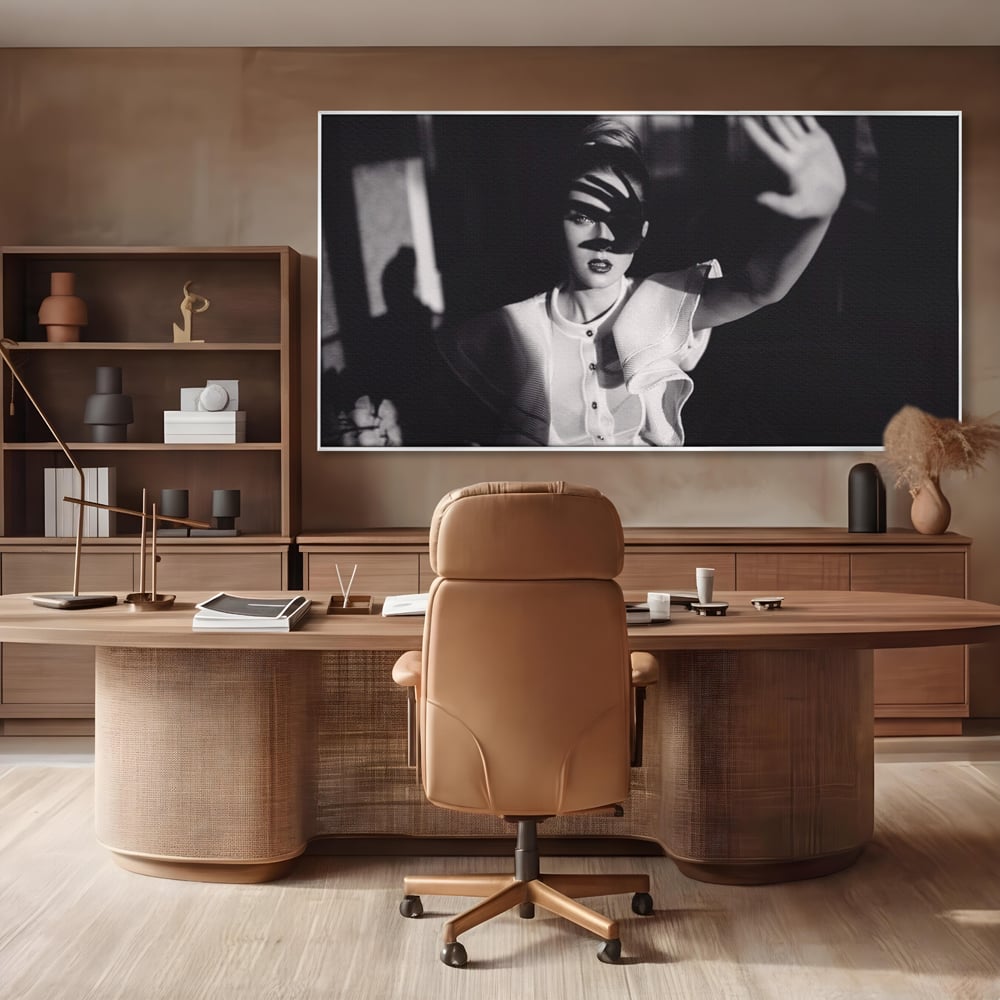 Tablou canvas cu tablou canvas cu femeie in alb si negru, in rama de aluminiu argintiu, pe perete intr-un birou